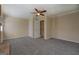 Spacious living room with a ceiling fan, neutral walls, and gray carpet at 34 Ivy St, Porterdale, GA 30014