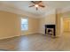 Cozy living room with light wood-look flooring and a traditional fireplace adding warmth to the space at 34 Ivy St, Porterdale, GA 30014