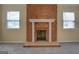 Cozy living room features a brick fireplace with white mantle and two windows at 34 Ivy St, Porterdale, GA 30014