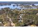 Aerial view showing lakefront home, pool, landscaping, and proximity to lake at 3320 Lost Valley Dr, Jonesboro, GA 30236