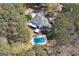 Aerial view of home and pool, mature trees, driveway and surrounding acreage at 3320 Lost Valley Dr, Jonesboro, GA 30236