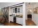 Convenient bar area with sliding barn door, wine fridge, sink, and storage, great for entertaining guests at 3320 Lost Valley Dr, Jonesboro, GA 30236