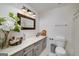 Well-lit bathroom features a single sink vanity, flowers and a toilet at 3320 Lost Valley Dr, Jonesboro, GA 30236