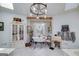 Bright bathroom with soaking tub, statement lighting, and decorative window at 3320 Lost Valley Dr, Jonesboro, GA 30236