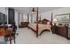 Elegant bedroom features four-poster bed, seating area, and natural light at 3320 Lost Valley Dr, Jonesboro, GA 30236