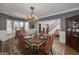 Charming dining room featuring a chandelier, wainscoting, and abundant natural light, ideal for Gathering gatherings at 3320 Lost Valley Dr, Jonesboro, GA 30236