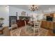 Open dining room features a chandelier, wood floors, and a view into the kitchen at 3320 Lost Valley Dr, Jonesboro, GA 30236