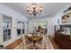 Dining room showcasing an elegant chandelier, a round dining table, and access to the outdoor patio at 3320 Lost Valley Dr, Jonesboro, GA 30236