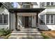 Inviting front porch featuring stone steps, elegant columns, and decorative planters enhancing the home's curb appeal at 3320 Lost Valley Dr, Jonesboro, GA 30236