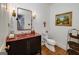 Stylish half bathroom featuring a unique red sink, modern fixtures, and decor elements that add character at 3320 Lost Valley Dr, Jonesboro, GA 30236