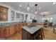 Spacious kitchen featuring an island cooktop, stainless steel appliances, granite counters, and light wood cabinets at 3320 Lost Valley Dr, Jonesboro, GA 30236