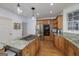 Open kitchen with wood cabinets, granite countertops, stainless appliances and center island with cooktop at 3320 Lost Valley Dr, Jonesboro, GA 30236
