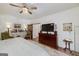 Bright main bedroom features a barn door, TV console and ceiling fan at 3320 Lost Valley Dr, Jonesboro, GA 30236