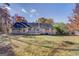 Wide backyard view, the gray house features a wooden deck and sunroom at 106 Kirkland Rd, Covington, GA 30016