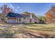 Wide backyard view, the gray house features a wooden deck and sunroom at 106 Kirkland Rd, Covington, GA 30016