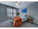 Comfortable bedroom with a ceiling fan and large window; includes a side table with a decorative lamp at 106 Kirkland Rd, Covington, GA 30016