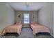 Cozy bedroom featuring two twin beds with patterned bedding and a window for natural light at 106 Kirkland Rd, Covington, GA 30016