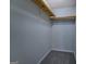 This is a picture of a carpeted walk-in closet with hanging shelves at 106 Kirkland Rd, Covington, GA 30016