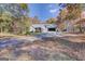 Charming single-story home with an attached garage surrounded by beautiful fall foliage and mature trees at 106 Kirkland Rd, Covington, GA 30016