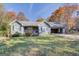 Charming single-story home with a cozy front porch and a convenient carport, surrounded by colorful autumn foliage at 106 Kirkland Rd, Covington, GA 30016
