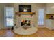 Cozy stone fireplace with a decorative mantel, providing a warm focal point in the living space at 106 Kirkland Rd, Covington, GA 30016
