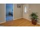 Bright foyer with hardwood floors, a decorative front door, and a view into an adjacent bedroom at 106 Kirkland Rd, Covington, GA 30016