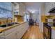 Bright kitchen features white cabinets, laminate countertops and wood look flooring at 106 Kirkland Rd, Covington, GA 30016