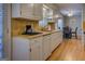 Functional kitchen with white cabinets, laminate countertops, and a view of the dining area for convenient meals at 106 Kirkland Rd, Covington, GA 30016