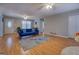 Bright living room with hardwood floors, a blue sofa, and an inviting atmosphere, perfect for relaxation and gatherings at 106 Kirkland Rd, Covington, GA 30016