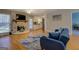 Inviting living room featuring hardwood floors, stone fireplace, and a glimpse into the kitchen for easy entertaining at 106 Kirkland Rd, Covington, GA 30016