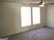 Bedroom with neutral carpet, two sunny windows and a ceiling fan at 851 Bridgewater Ct, Stone Mountain, GA 30088
