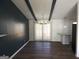 Dining room with modern chandelier, breakfast bar, dark accent wall, and sliding glass door at 851 Bridgewater Ct, Stone Mountain, GA 30088