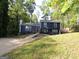 Charming two-story home featuring a well-manicured front yard with lush trees and a concrete driveway at 851 Bridgewater Ct, Stone Mountain, GA 30088