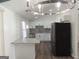 Bright kitchen featuring a breakfast bar, stainless steel appliances, white cabinets, and modern lighting at 851 Bridgewater Ct, Stone Mountain, GA 30088