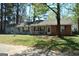 Charming one-story home with light blue siding, brick accents, red shutters, and a welcoming front porch at 121 Juniper Dr, Mcdonough, GA 30253
