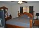Relaxing main bedroom with wood furniture, ceiling fan, and neutral colors, creating a calm atmosphere at 121 Juniper Dr, Mcdonough, GA 30253