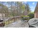 Backyard deck featuring outdoor seating, a grill and wooded view at 2733 Newtons Crest Cir, Snellville, GA 30078
