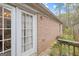 Backyard entrance with brick exterior and a white door, offering easy access to outdoor living and entertaining at 2733 Newtons Crest Cir, Snellville, GA 30078