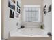 Relaxing bathroom showcasing a soaking tub and window with natural lighting at 2733 Newtons Crest Cir, Snellville, GA 30078