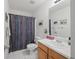 Clean bathroom features a shower with curtain, vanity and toilet at 2733 Newtons Crest Cir, Snellville, GA 30078
