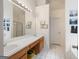 Well-lit bathroom with double sinks, vanity, and a large mirror at 2733 Newtons Crest Cir, Snellville, GA 30078