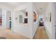 Bright hallway view to the kitchen with a black fridge and red wall at 2733 Newtons Crest Cir, Snellville, GA 30078