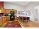 Open kitchen and dining area with light wood cabinetry and an adjacent dining space that provides functionality and style at 2733 Newtons Crest Cir, Snellville, GA 30078