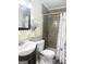 Bathroom featuring a shower, neutral walls, and a dark vanity with elegant sink at 6544 Bussell Way, Riverdale, GA 30274