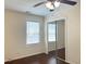 Bedroom with hardwood floors, mirrored closet doors, and natural light from a window at 6544 Bussell Way, Riverdale, GA 30274