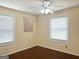Bright bedroom with hardwood floors, two windows providing plenty of natural light and neutral paint at 6544 Bussell Way, Riverdale, GA 30274