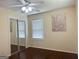 Comfortable bedroom with mirrored closet doors, hardwood floors and large windows at 6544 Bussell Way, Riverdale, GA 30274