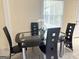 Modern dining area with black dining set, seating for four and natural light at 6544 Bussell Way, Riverdale, GA 30274