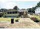 Single-story home with a brick accent wall and a covered front porch and sunroom at 6544 Bussell Way, Riverdale, GA 30274