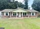 Charming one-story brick home featuring a well-manicured lawn and a welcoming front entrance at 6544 Bussell Way, Riverdale, GA 30274